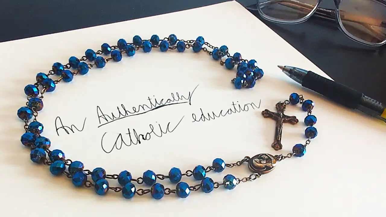 Rosary on paper with handwritten text