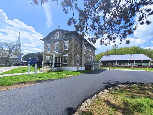 Historic Our Lady Seat of Wisdom College building with surrounding greenery.